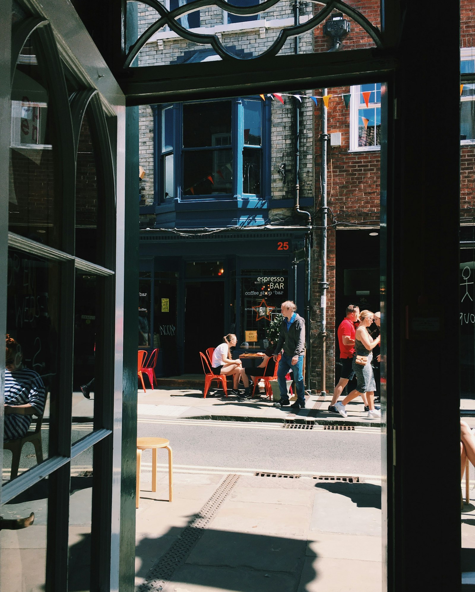 Sidewalk café and local businesses on a city street