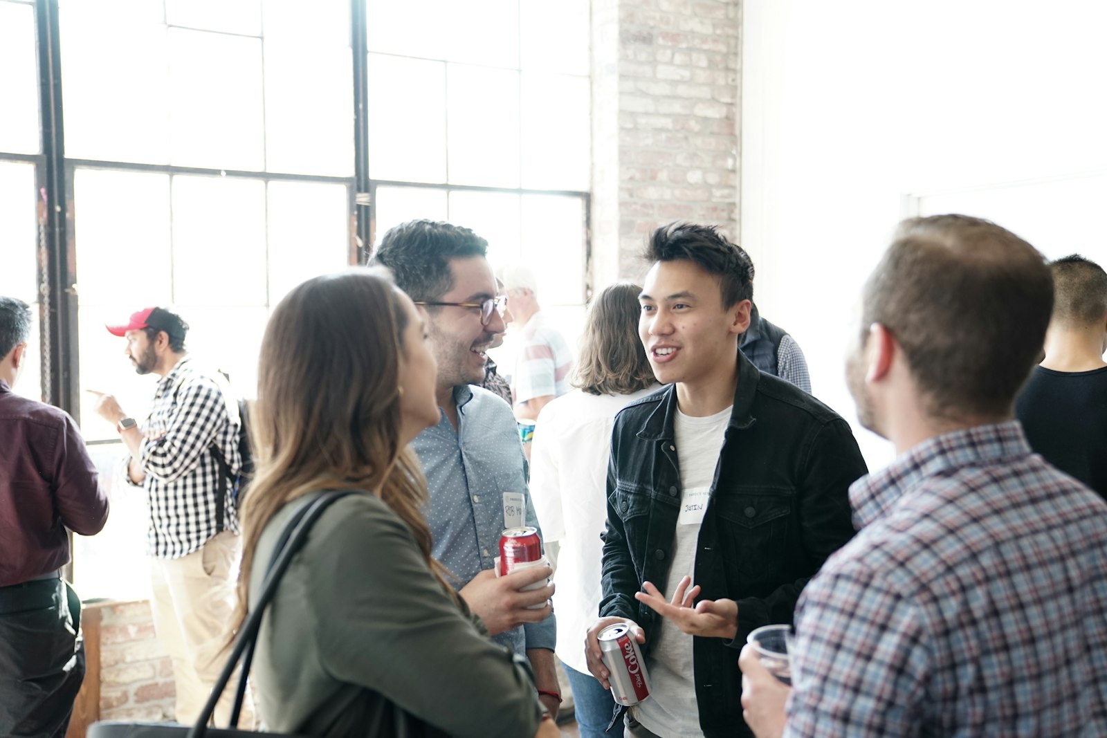 Business people with name tags talking at a networking event